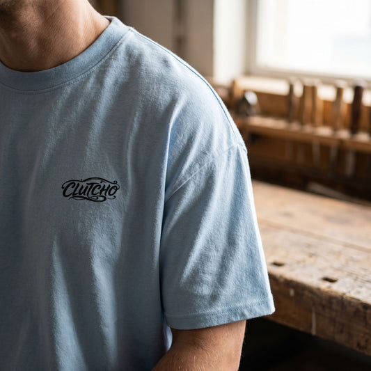Close-up of Tokyo Night Drive Oversized Shirt showing dropped shoulders and brushed cotton texture with a blurred wooden background.