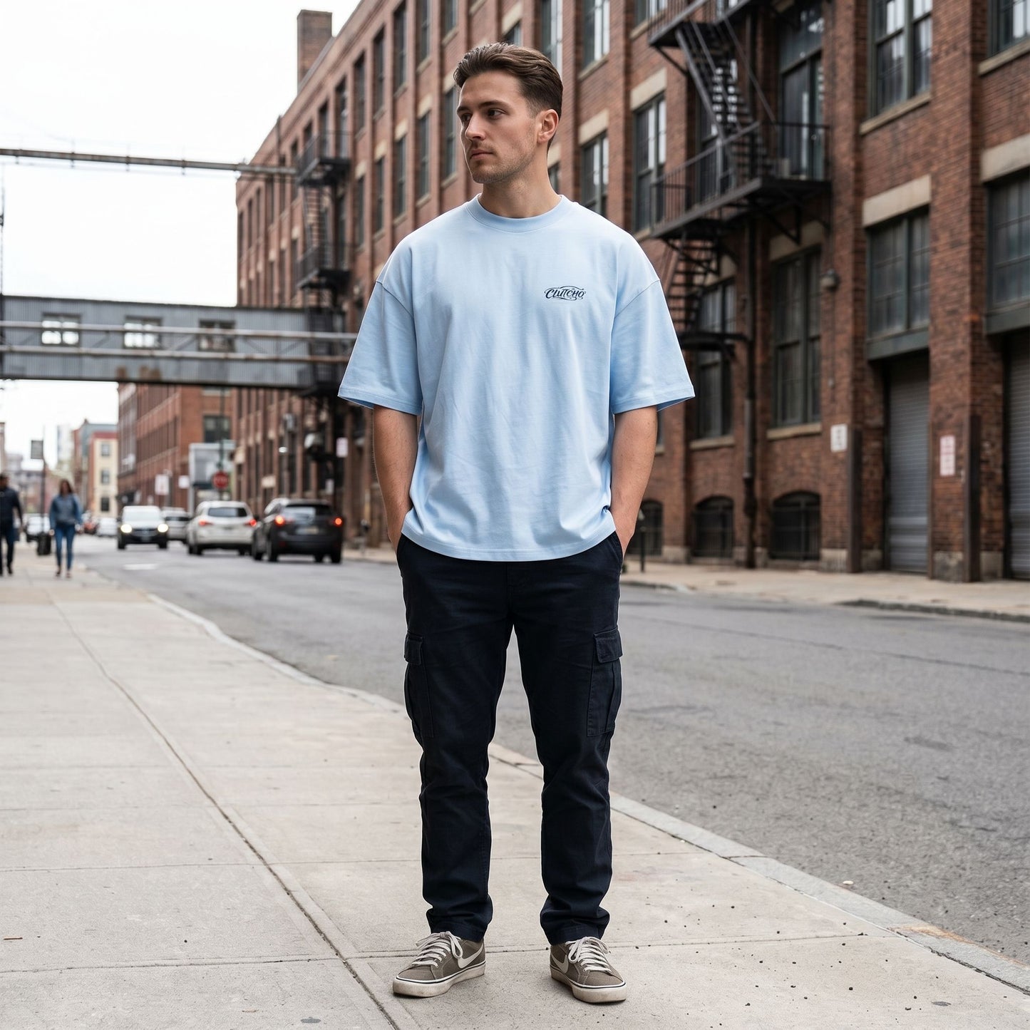 Full-body shot of the oversized shirt in an urban environment, highlighting its relaxed fit and heavy cotton material.