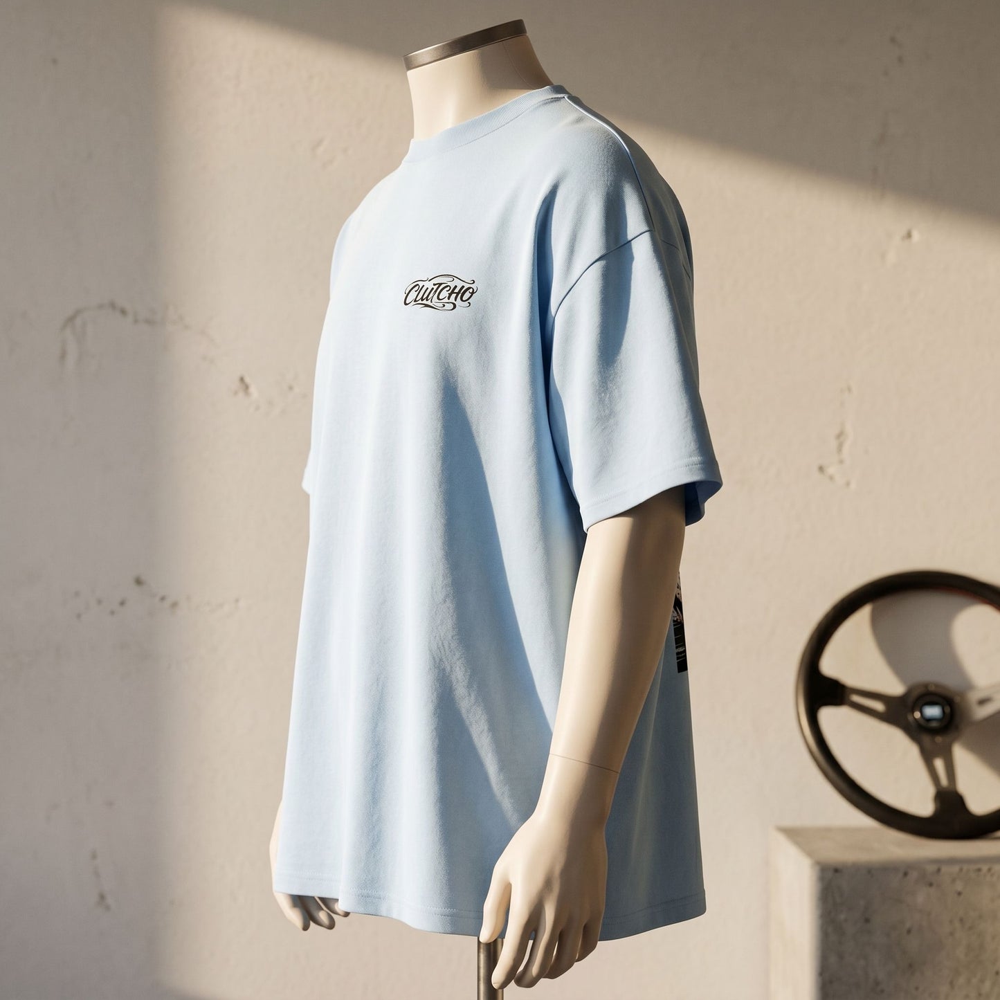 Side profile of Tokyo Night Drive Oversized Shirt on mannequin, highlighting drop shoulder and brushed cotton in soft afternoon light.